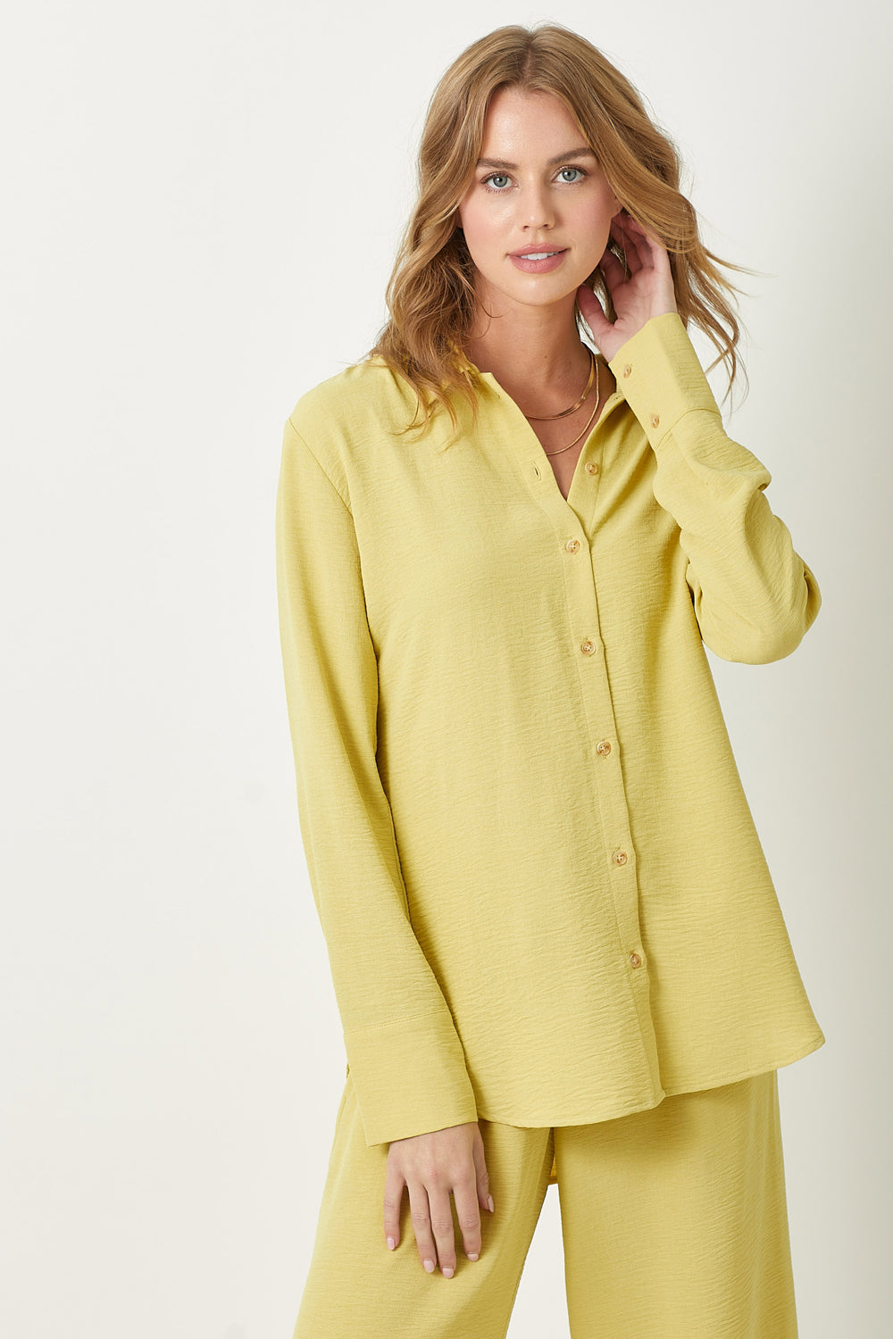 Elevate your wardrobe with this playful Muted Lemon Button Down Blouse. Versatile for office or casual outings.