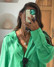 Load image into Gallery viewer, A woman in a green shirt accessorizes her outfit with a pearl and gold chain necklace featuring a unique freshwater pearl on a chunky gold chain.
