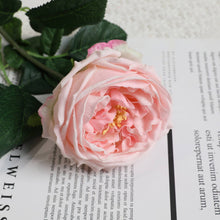 Load image into Gallery viewer, Real touch pink rose atop a book, adding a soft and delicate touch to artificial flower arrangements and wedding bouquets.

