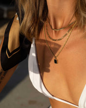 Load image into Gallery viewer, A woman in a white bikini top and a gold figaro chain necklace, perfect for layering or wearing solo. Necklace measures 44 cm with an 8 cm extension chain.
