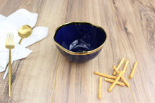 Load image into Gallery viewer, Luxurious blue glazed porcelain bowl with gold-tone rims, ideal for condiments or snacks. Food safe, dishwasher safe, oven safe to 500°.
