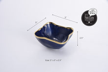 Load image into Gallery viewer, Square snack bowl in Sunset By The Sea. Perfect for individual snacking, dips, or toppings. Adds elegance to any bar with lemons and limes. Made of blue glazed porcelain with gold-tone rims. Food safe, dishwasher safe, and oven safe to 500°. Easy to care for.
