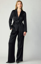 Load image into Gallery viewer, Sophisticated black suit with cinched waist, notched lapels, and flap pockets, perfect for formal occasions.
