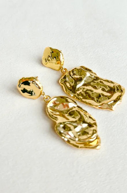 A pair of gold earrings featuring an elegant leaf design, showcasing the craftsmanship of Easton Elle.
