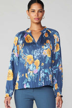 Load image into Gallery viewer, A stylish blue floral blouse with a flattering v-neck design. Perfect for a trendy and feminine look.
