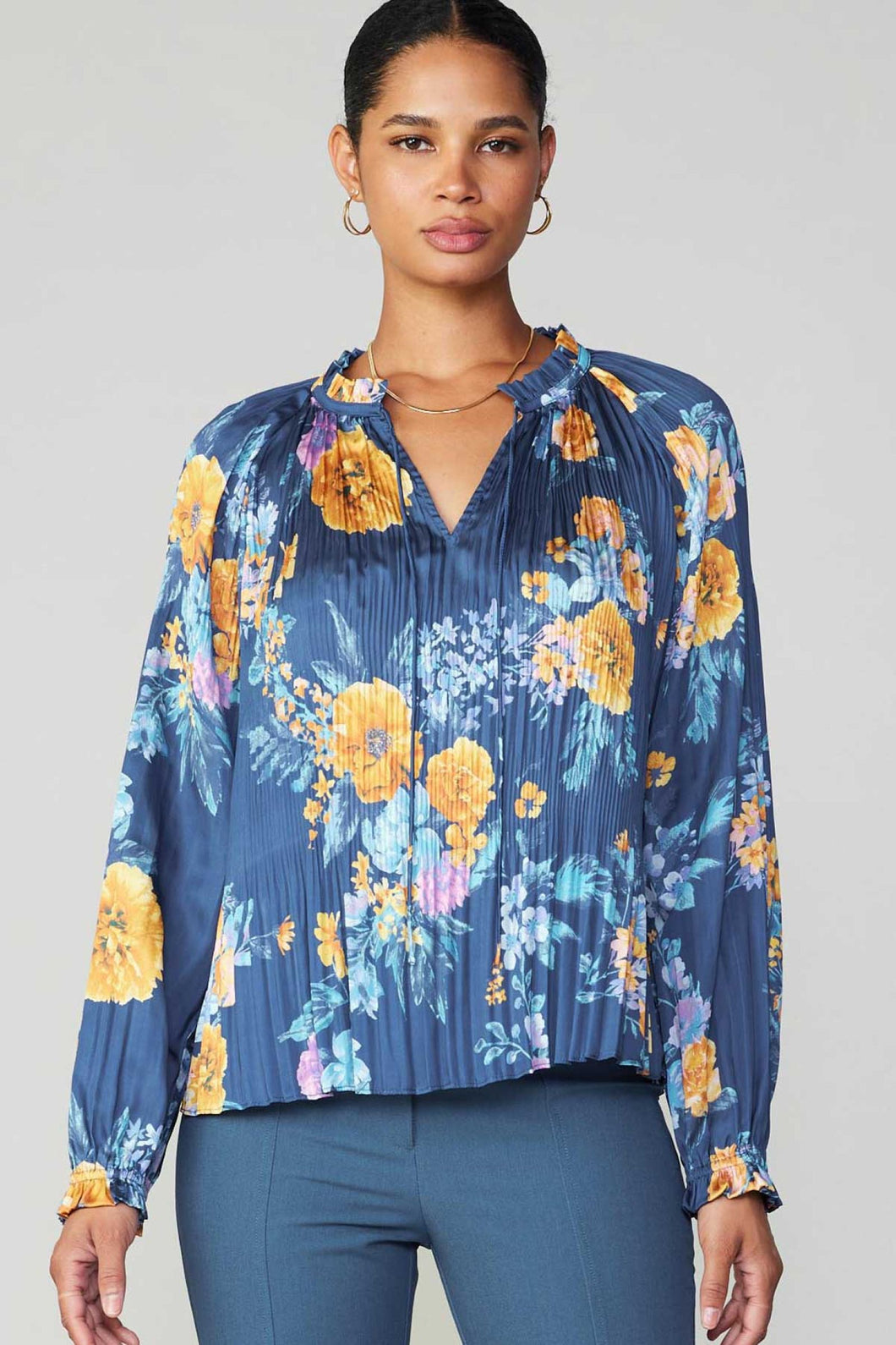 A stylish blue floral blouse with a flattering v-neck design. Perfect for a trendy and feminine look.
