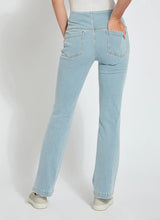 Load image into Gallery viewer, Woman wearing stretchy Knit Denim jeans with studded back pockets and contrast-color top stitching.
