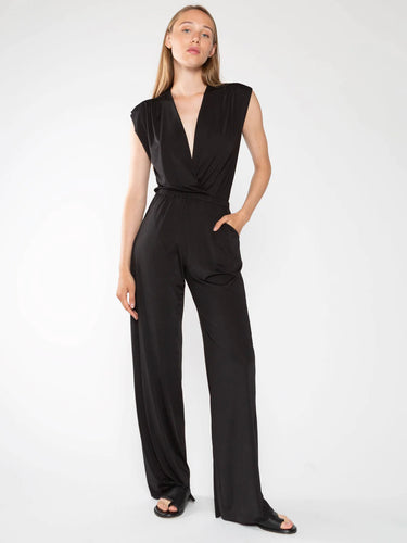 Ripley Rader's black jumpsuit: stretchy microfiber fabric, elastic waist, deep pockets, gathered shoulders, optional plunging neckline. Wrinkle-free, sleek look.