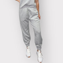 Load image into Gallery viewer, Indulge in comfort with these elegant black scuba joggers, designed with an elastic waistband, drawstring, and side pockets.
