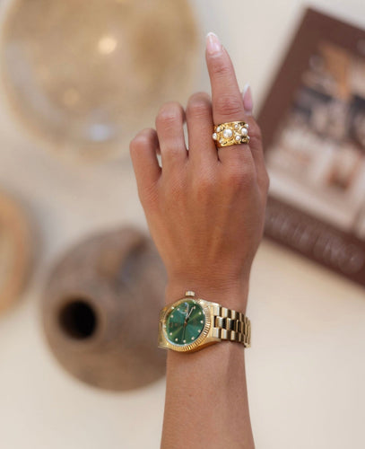 Ornate gold and silver rings with pearls. Offers elegance and sophistication.