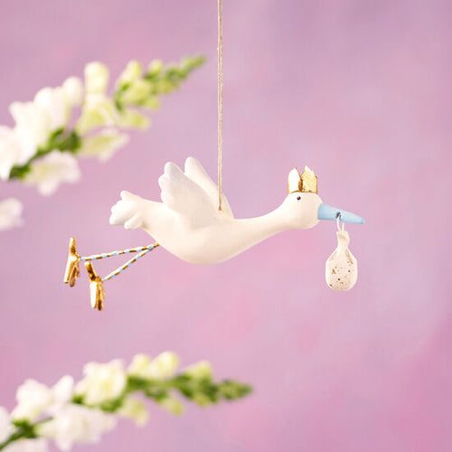 Hand-painted 7.5” resin Flying Stork Ornament, gilded with gold leaf, adds elegance and whimsy to holiday decor.