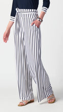 Load image into Gallery viewer, Elegant woman donning striped wide-leg pants with a fashionable waistband and chic sash.
