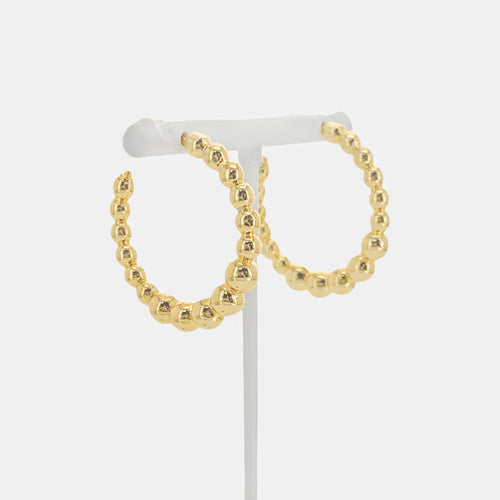 Hoop earrings with bubble pattern design. Earring post slides into ears, secures with push back backing.
