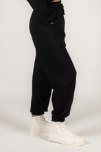 Load image into Gallery viewer, Dani Black Scuba Joggers feature soft fabric, elastic waistband, drawstring, cuffs, and side pockets for ultimate comfort.
