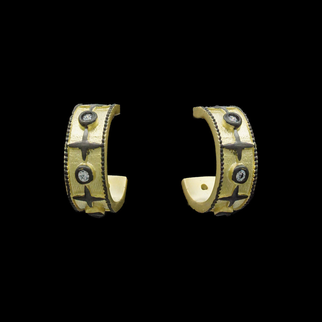 Two elegant gold and black diamond hoop earrings, designed as small post earrings, showcasing a sophisticated style.