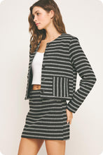 Load image into Gallery viewer, Woman wearing a black and white patterned outfit on a plain background
