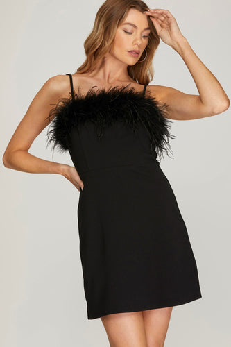 Sophisticated black dress featuring stylish feather embellishments on the shoulders.
