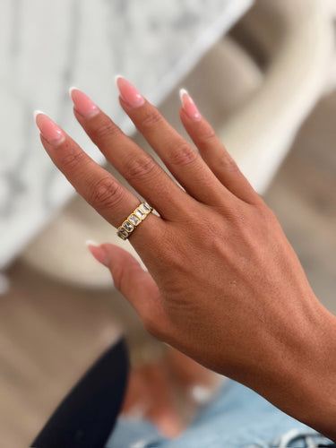 A gold band ring with clear gemstones. A statement and everyday piece to add to your stack or rotation.