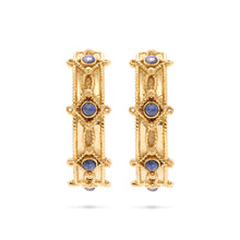 Load image into Gallery viewer, A pair of hammered gold hoop earrings adorned with blue sapphires, showcasing elegance and sophistication.
