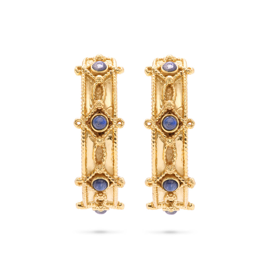 A pair of hammered gold hoop earrings adorned with blue sapphires, showcasing elegance and sophistication.