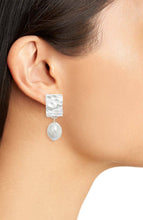 Load image into Gallery viewer, These lightweight clip-on earrings have elongated frames with varied textures and large irregular white faux pearl dangles.
