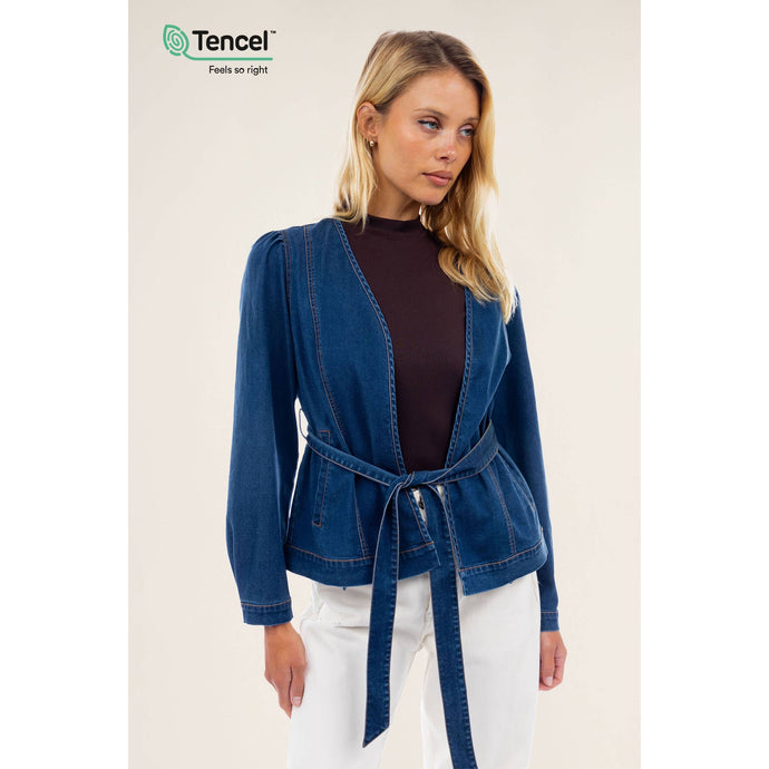 A blue denim wrap top with belt and white pants. Can be worn as a jacket or top. Belt adds a shaping factor making this piece elegant and versatile