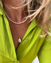 Load image into Gallery viewer, This pearl pendant necklace features a unique 1.5 cm long natural baroque pearl on a dainty gold block chain. It measures approximately 46 cm in length and comes with an 8 cm extension chain. Ideal for layering with other necklaces.
