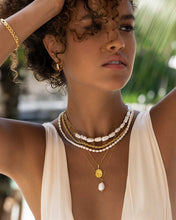 Load image into Gallery viewer, The elegance of a woman in a white dress is enhanced by a sophisticated gold necklace, adding a touch of luxury to her appearance.
