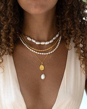 Load image into Gallery viewer, Stylish woman with curly hair showcasing a pearl pendant necklace, enhancing her ensemble with timeless elegance.
