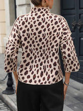 Load image into Gallery viewer, Person wearing a leopard print top with a blurred background

