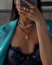 Load image into Gallery viewer, A woman in a blue suit and gold jewelry, wearing a chic half pearl half chain necklace with rectangular freshwater pearls and a trendy paper clip chain.
