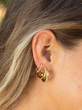 Load image into Gallery viewer, The gold hoop earrings, worn by a woman, are a perfect accessory. Hexagon shape with crystal encrusting adds texture and shine.

