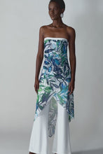 Load and play video in Gallery viewer, A woman in a blue and green dress posing, exuding grace in a silky knit strapless jumpsuit with a vibrant tropical print.
