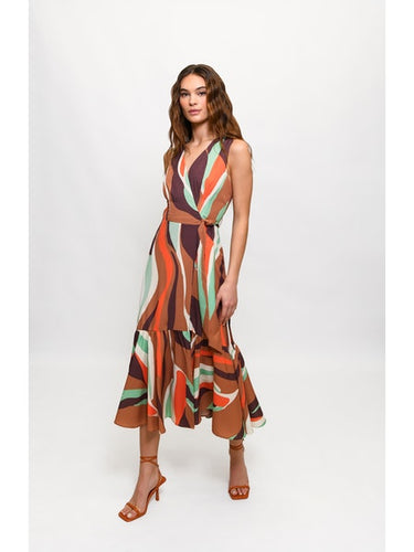 Wrapped in style, the model dons a stunning multi-colored dress with a v-neckline. The Hutch Drea Dress, a playful and elegant midi dress, features a flattering surplice wrap design. Whether it's a casual or special event, this dress will make you feel both confident and chic.