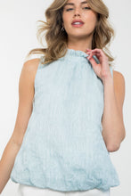 Load image into Gallery viewer, A light blue sleeveless top made from a textured fabric with playful flower details, perfect for adding quirkiness to any outfit.

