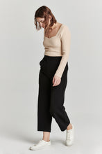 Load image into Gallery viewer, Soft and stretchy cropped wide leg pants in black. High rise, flattering silhouette, and comfortable fit. Versatile and stylish for any occasion.

