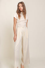 Load image into Gallery viewer, Cream top and wide leg pants by Line and Dot. Luxurious Ecru hue, classic yet modern design, crafted with premium materials for exquisite style.

