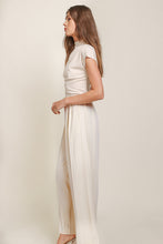 Load image into Gallery viewer, A model in cream top and wide leg pants by Line and Dot. Luxurious Ecru hue, classic yet modern design, crafted with premium materials.
