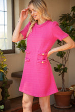 Load image into Gallery viewer, A woman in a pink dress and pink shoes, wearing the Business Barbie Dress, a fashionable and functional hot pink tweed dress with a unique braided neckline and double pockets. Unleash your inner boss!
