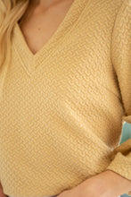 Load image into Gallery viewer, Elevate your style with our unique design and pearl detailing. Textured fabric adds dimension, while bell sleeves and v-neck create a flattering silhouette. Take on any challenge in this top!
