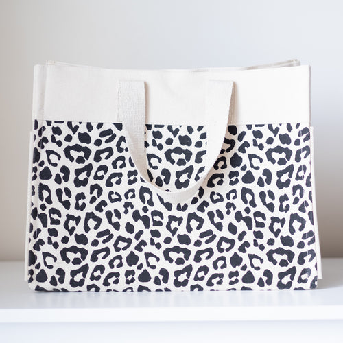 A stylish Malawi Manhattan Cheetah Cotton Tote Bag, perfect for beach or pool vacations. Personalize with a name or monogram for a unique touch.