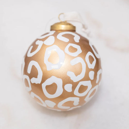 Gold Christmas ball with white leopard spots, 4 inches.