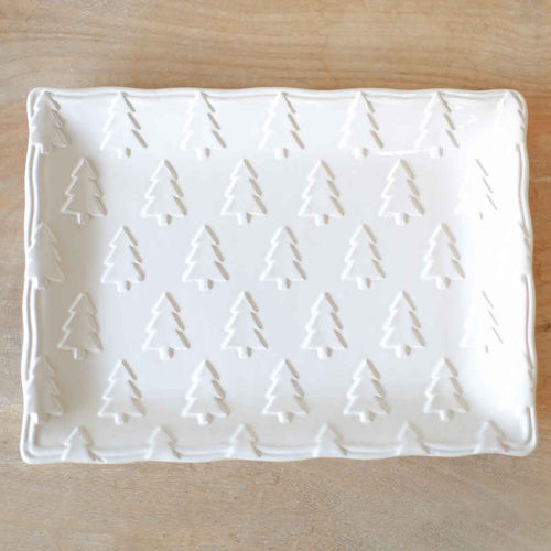 White Christmas platter with embossed trees, perfect for holiday parties.