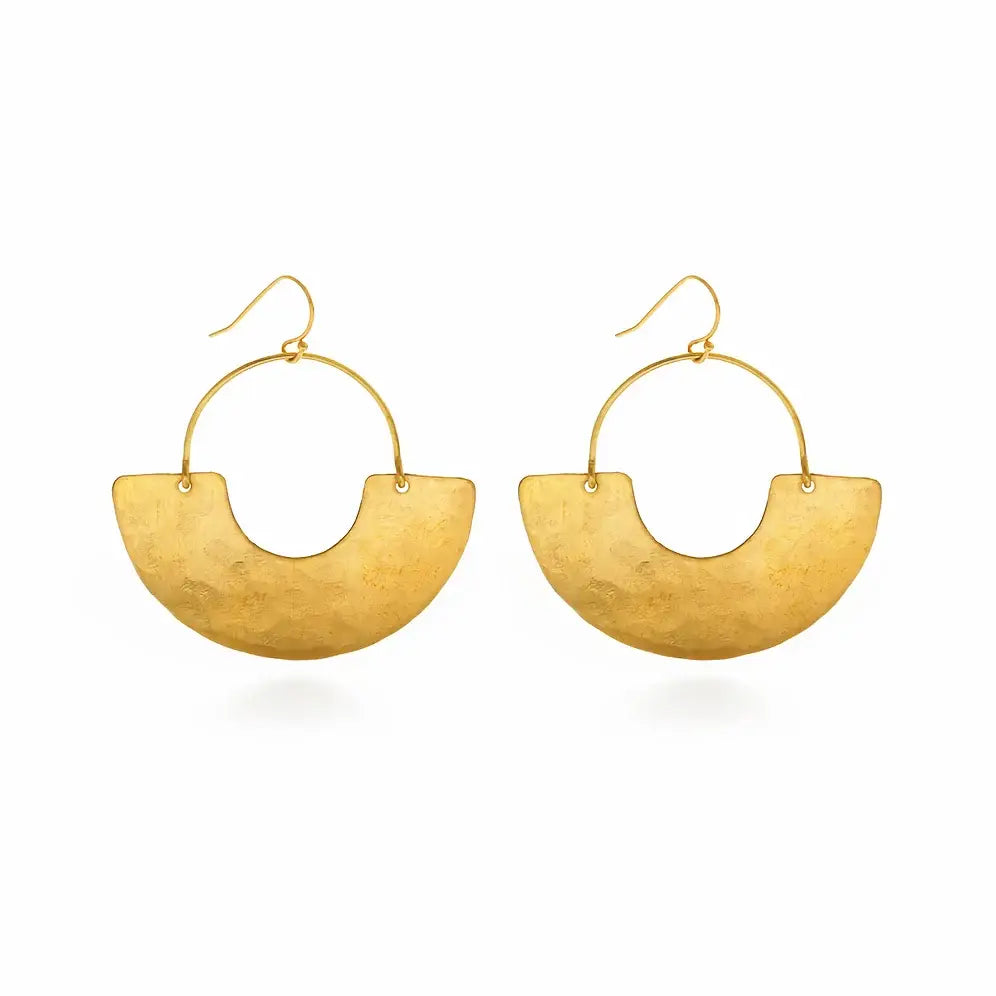 Gold earrings, crafted from hammered brass, dangle elegantly from a branch. Handmade in the USA, packaged on our 3.5