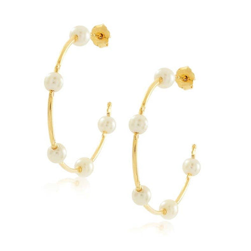 Elegant gold hoop earrings with lustrous pearls, perfect for adding a touch of sophistication to any outfit.