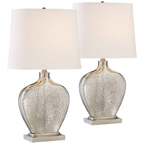 Mercury glass table lamp with brushed steel base, silver finial, and white fabric shade. Elegant addition to any space.