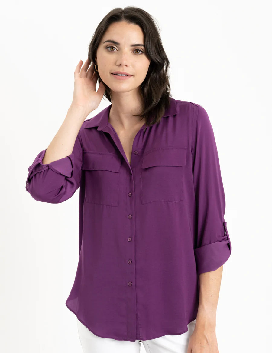 Airflow fabric shirt dyed using eco-friendly method. Versatile for dressy or casual occasions. Features button front, collar, patch pockets, curved hem, back yoke, and roll-tab sleeves.