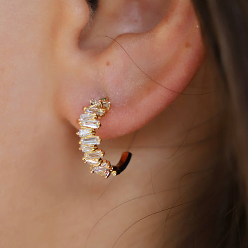 Tapered Baguette CZ Hoops: edgy and glamorous earrings with off-set baguette cut jewels for the perfect sparkle. Dress them up or down, and double-stack with our Single CZ Ear Cuff for a stylish look.