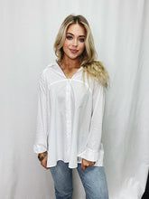Load image into Gallery viewer, Elegant white button-down blouse with a bow detail at the back, made from 100% cotton for comfort and style.
