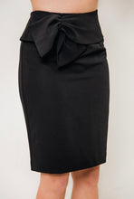 Load image into Gallery viewer, An elegant woman donning a black skirt with a bow, featuring the stylish Black Bow Waist Skirt by Posh Couture.
